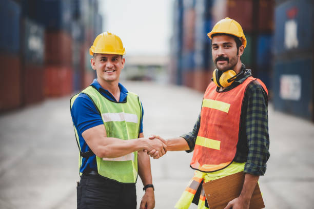 istock engineer foreman working in container terminal in term of industry logistic cargo shipping to export and import, warehouse delivery business freight transport, loading control in port with safety 1325772006