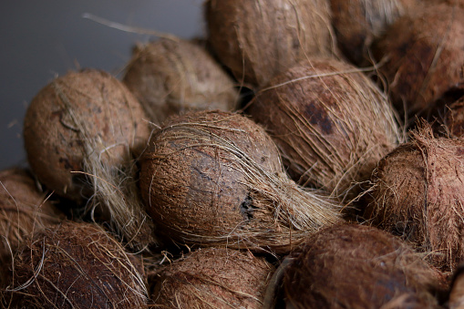 Large group of coconut for sale in market.