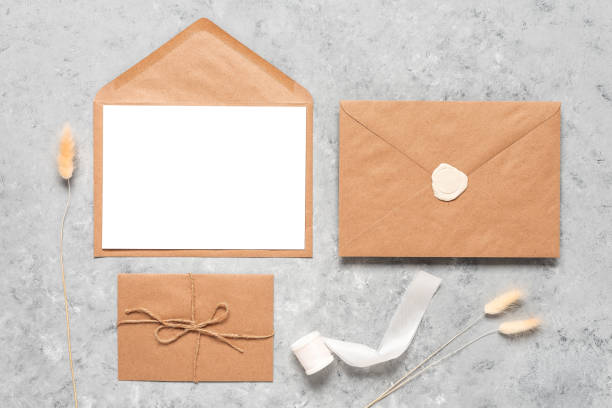 istock Wedding invitation card template. Blank greeting card mockup, brown envelopes and dried grass. Autumn stationery scene. Top view, flat lay. 1325774567