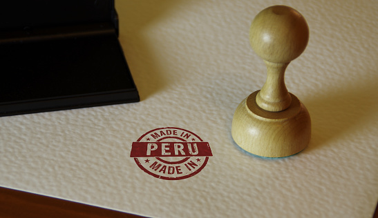 Made in Peru stamp and stamping hand. Factory, manufacturing and production country concept.