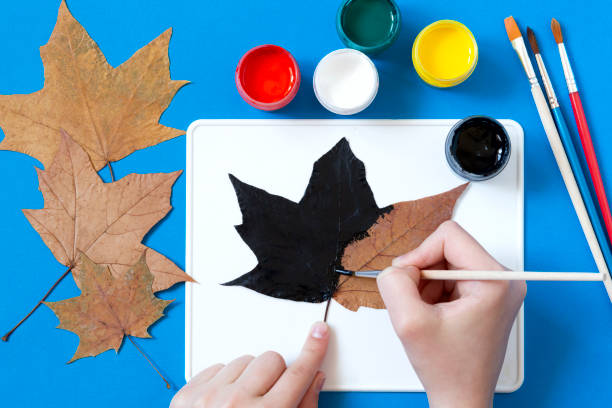 istock Drawing Halloween characters on dry autumn leaves. Step 4 1325783750
