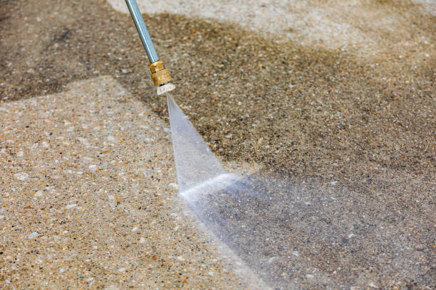 Pressure washing dirty concrete driveway. Home cleaning, maintenance and household chores concept stock photo