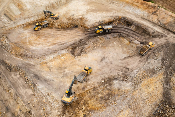 istock Aerial view of excavators digging ground. Opencast mining quarry. 1325785592