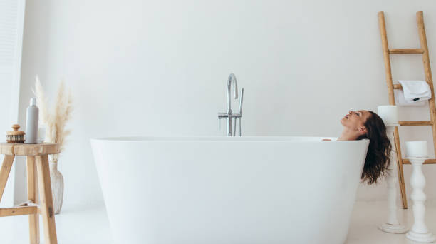 istock Woman lying in bathtub with eyes closed. 1325785613