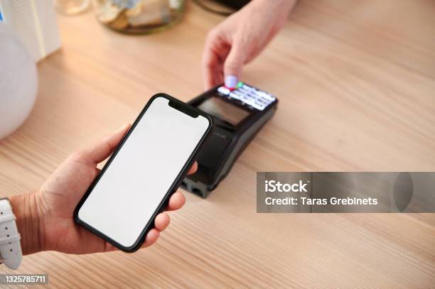 A Customer Making A Contactless Payment Using Online Application On Smartphone Closeup Of Owner And Customer Accounting With Contactless Payment Stock Photo - Download Image Now