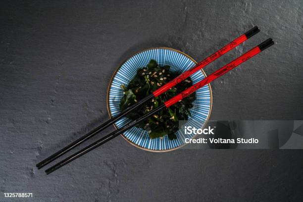 High Wakame Sald In A Bowl With Chopsticks Stock Photo - Download Image Now - Chopsticks, Wakame, Advice