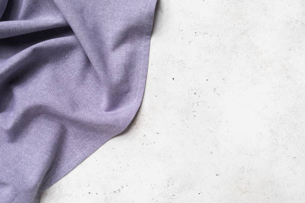 Purple napkin on the left side of the abstract background with copy space, food background stock photo