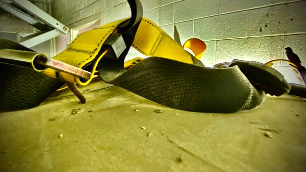 a discarded yellow safety harness - abstract