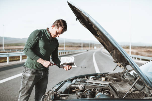 istock Male Checking Car Oil On Highway 1325790109
