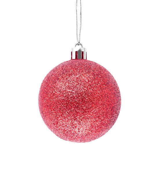 istock Hanging red glitter Christmas bauble isolated on white background. 1325790973