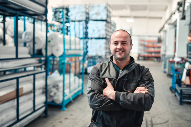 istock Smiling Warehouse Worker In Textile Factory Material Warehouse 1325792211