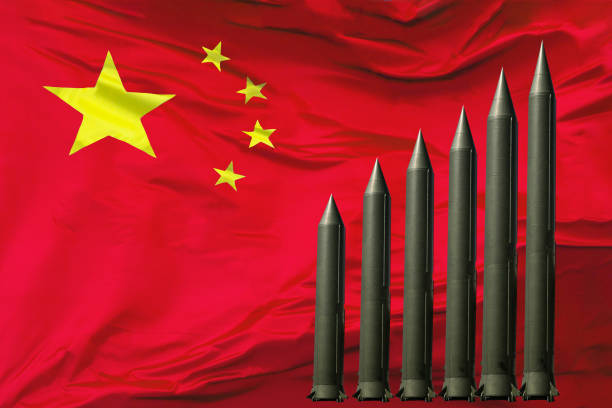 istock China weapon.  Chinese flag on abstract rocket background 1325793042