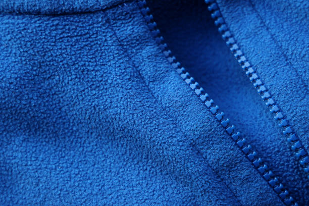 Close shot of simple blue fleece fabric with zip fastener Close shot of simple blue fleece fabric with zip fastener fleece photos stock pictures, royalty-free photos & images
