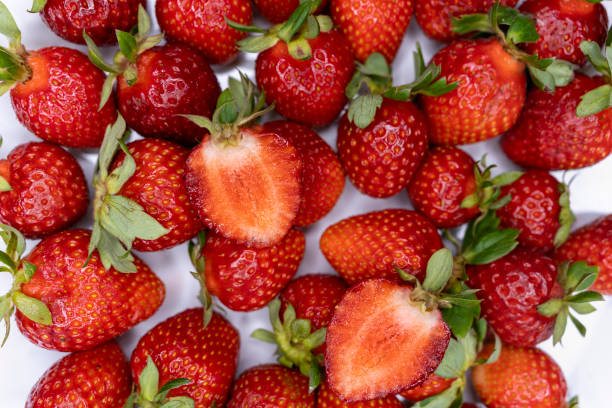 istock Juicy beautiful red strawberries. Sliced sugar strawberries. Background with 1325794395