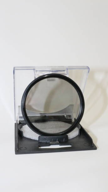 istock Isolated filter lens on white background, vertical image. Photography equipment, accessory. Plastic box 1325795173