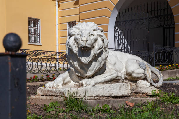 Old dilapidated sculpture of a reclining lion.