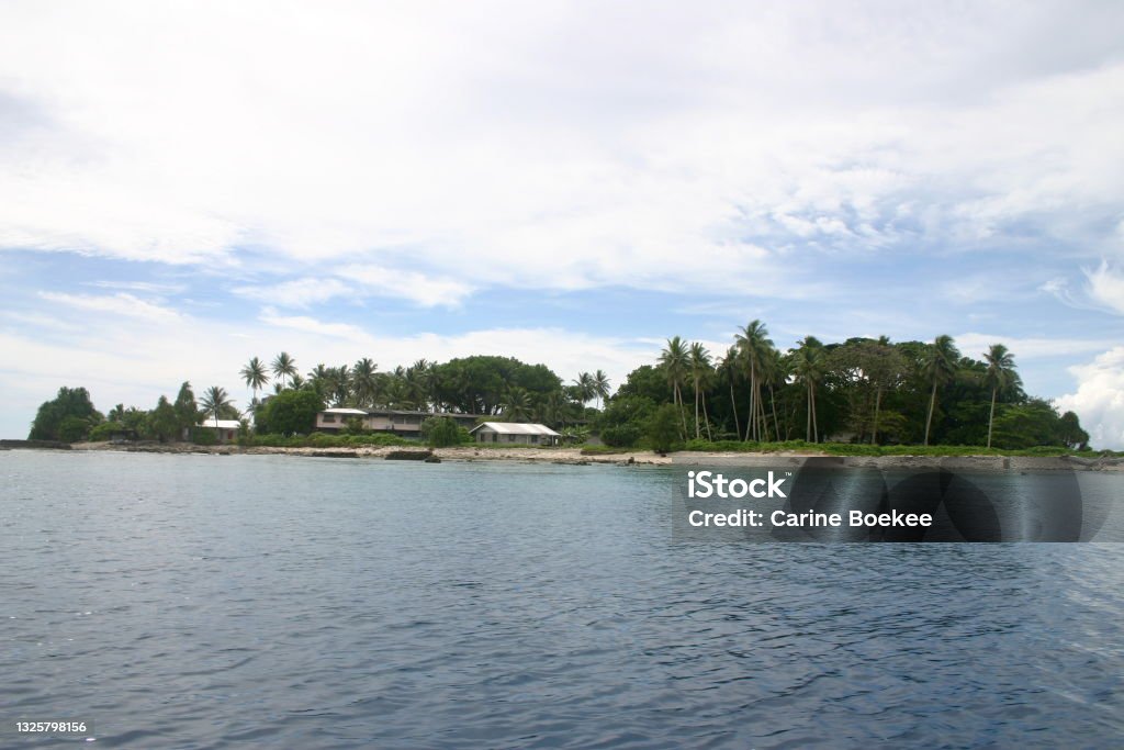 Jaluit atoll, Marshall Islands - Northern tip of Jabor island seen from the water View of the northern tip of Jabor island as seen from a boat on the water. The principal's house and the old high school are visible. Marshall Islands Stock Photo