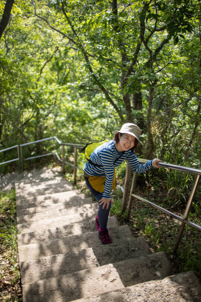 Young woman walking up steps on mountain