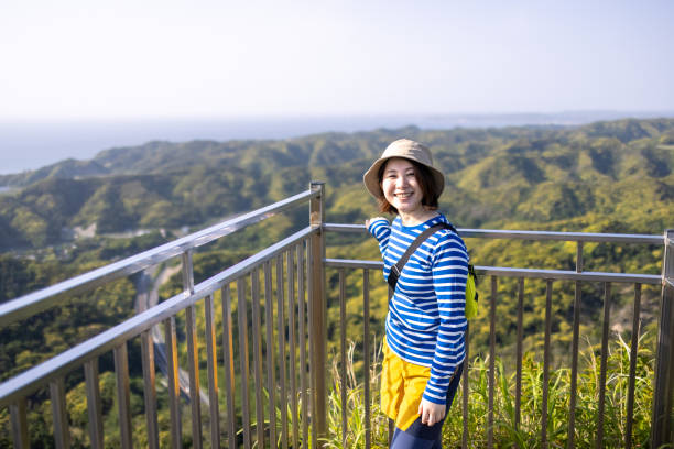 istock Young woman looking at view from observatory on mountain 1325798802