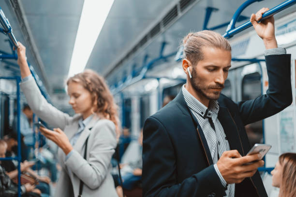 passengers in a subway car standing at a safe distance