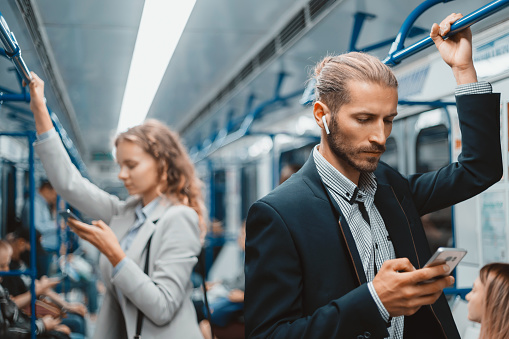 passengers in a subway car standing at a safe distance . urban lifestyle.