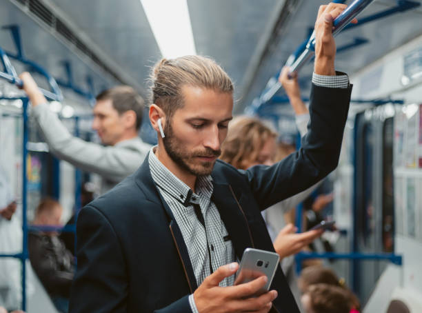istock young man reading his correspondence in the subway 1325799565