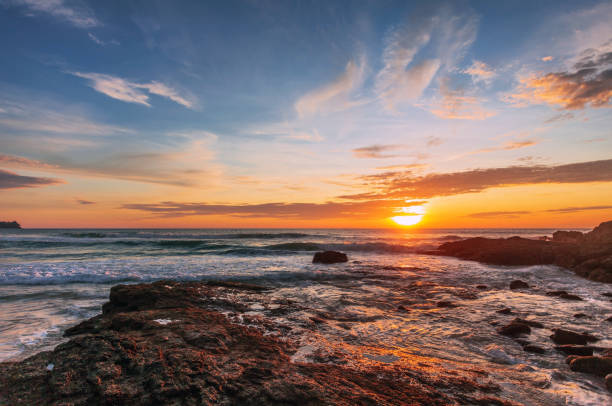 istock Beautiful sunset on the rock beach. 1325799744
