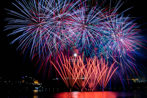 istock Fireworks over downtown fill the night sky and reflect on the river 1325801688