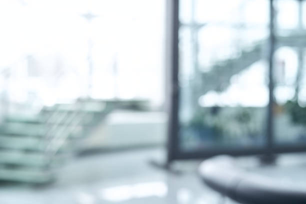 blurry image of a large window and a staircase in an office building stock photo