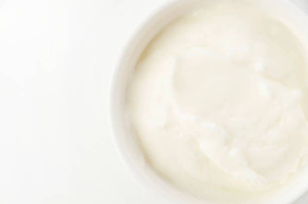 istock Fresh greek yogurt in Ceramic white Ramequin on white background 1325802750
