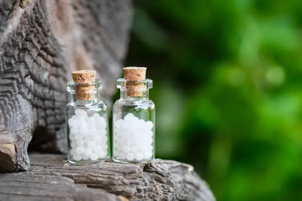Two bottles of homeopathy globules. Bottles of homeopathic granules. Homeopathy medicine concept.