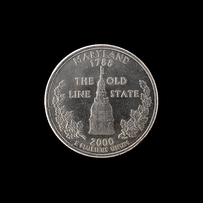 quarter of a US dollar coin isolated on black background