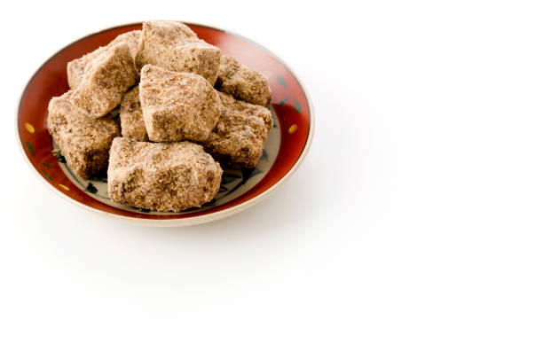 brown sugar lump in plate on white background