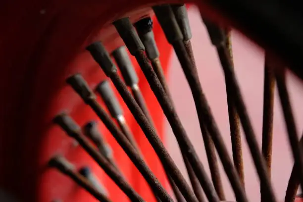 Photo of Detail macro automotive photography. Close up old rustic wheel bars.