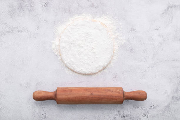 istock Fresh homemade yeast dough resting on whote concreate background flat lay with rolling pin. 1325811771