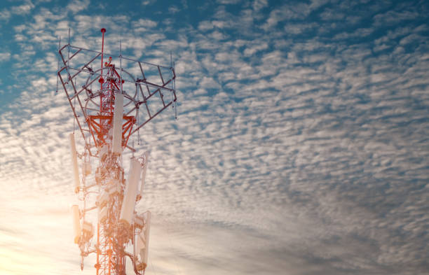 istock Telecommunication tower with blue sky and white clouds background. Antenna on blue sky. Radio and satellite pole. Communication technology. Telecommunication industry. Mobile or telecom 4g network. 1325814623