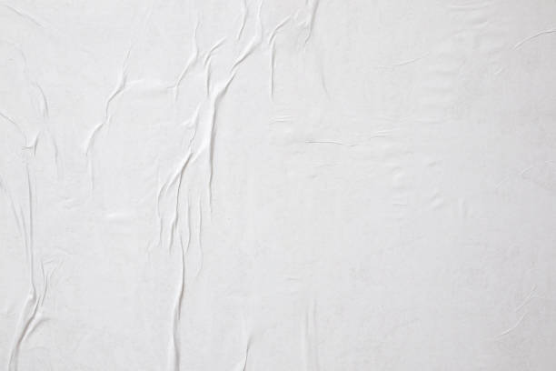 istock Blank white crumpled and creased paper poster texture background 1325815200