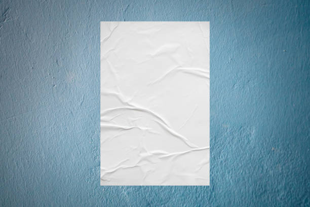 istock Blank white wheatpaste glued paper poster mockup on concrete wall background 1325815232