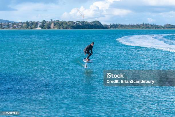 Foil Board Er Just Dropped Tow Rope From Jetski On Auckland Harbor Stanley Bay Stock Photo - Download Image Now