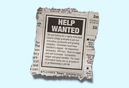 A retro help wanted classified ad from the classified section of a newspaper. Isolated on a light blue background.