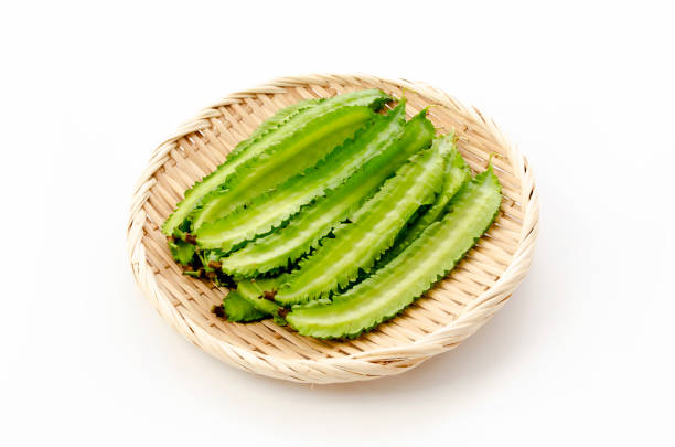 istock Fresh Winged beans on a bamboo sieve on a white background 1325822024