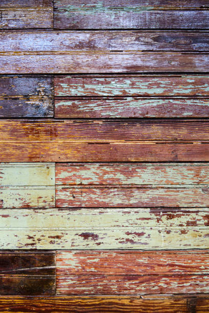 istock Texture, old grungy paint-striped wood slatted wall covered with peeling paint. 1325824600