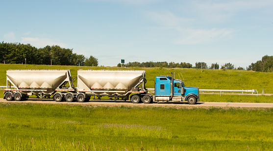 A truck hauling freight along a highway. Taken in Alberta, Canada