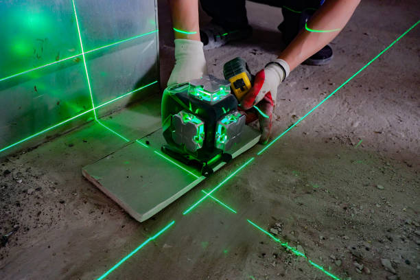 istock the builder measures the repair lines using a green laser level 1325828254