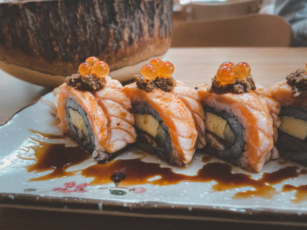 sushi roll with salmon and salmon roe on top. sushi menu. japanese food. - buffet japanese cuisine lifestyles ready to eat imagens e fotografias de stock