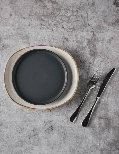 istock Empty plates, forks on grey concrete background. Top view, concept mockup. 1325834803