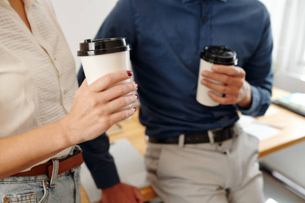 istock Business people with coffee cups talking 1325836870