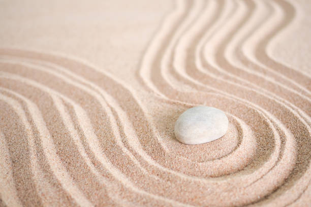 istock Japanese zen garden stone on wave sand beach. 1325838777