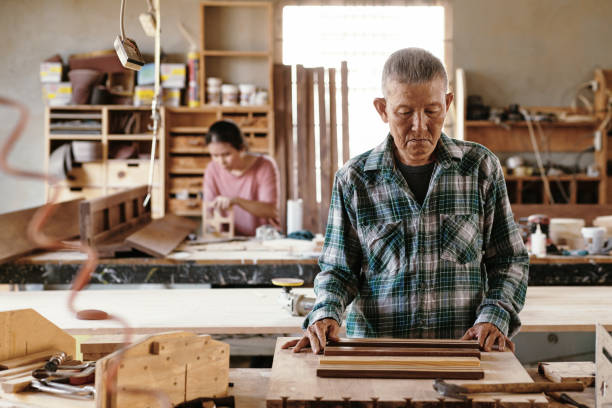 istock Pensive Carpenter Looking at Wooden Pieces 1325838778