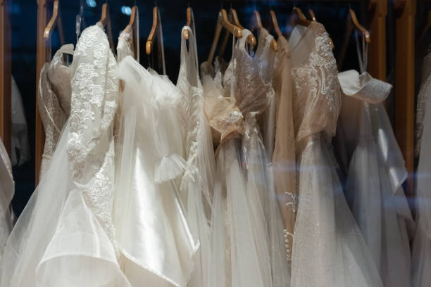 istock Wedding dresses in the shop window close up 1325839936